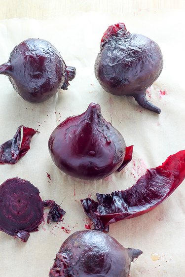 Roasted beets with the outer layer of skin peeled away.