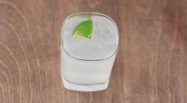 gin and tonic garnished with lime