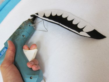 gluing the shark mouth onto the costume
