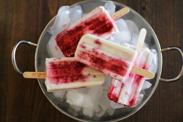 Marbled ice pops on a bowl of ice.