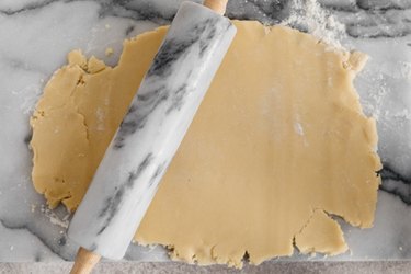 Use a lightly floured rolling pin to roll out the dough.