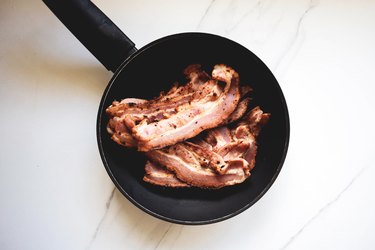 Crispy bacon in a fry pan.