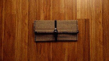 Upcycled no-sew clutch from a bamboo placemat and faux patent leather belt
