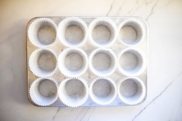 Line a 12 hole muffin tin with paper liners.