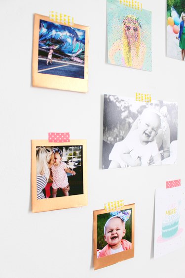 Photos on a wall with decorate tape.