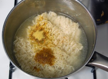 Ramen with curry powder, seasoning packet and chopped ginger