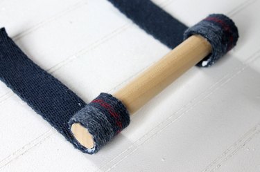 roll wooden dowel onto webbing strips