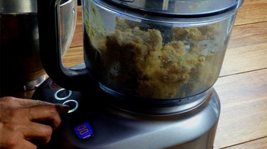 Combining ingredients for gluten-free, low-carb coconut flour rolled pie crust in food processor.
