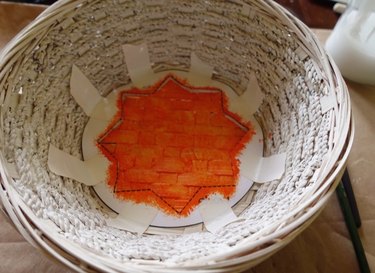 Using stencil to paint DIY desert-style baskets.