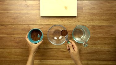 Mixing instant coffee and hot water for easy way to stain wood with coffee.