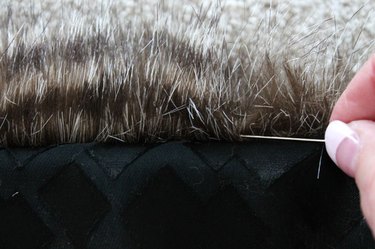 Use a pin to release any fur that is caught in the seam.