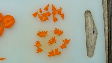 Cutting feet from carrot chips for deviled egg Easter chicks.