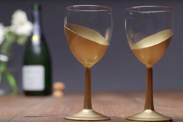 Asymmetrical gold designs on wine glasses