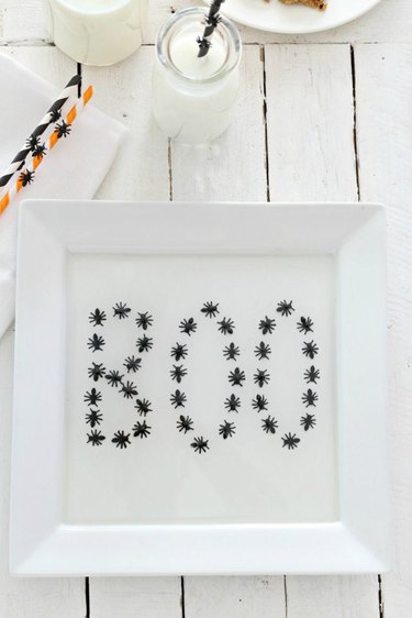 A white tray with boo written in spiders