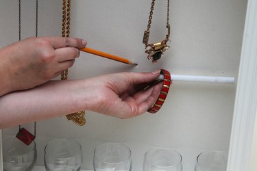 Mark the hook locations to hold the dowel.