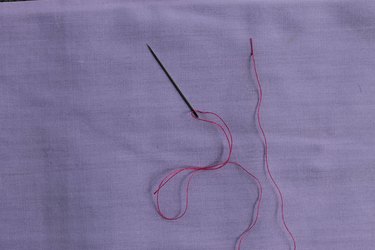 Inserting the needle through the original entry point for zig zag stitch