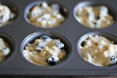 Muffin tray with batter.