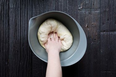 Hand kneading pizza dough