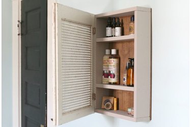 Open medicine cabinet with Burt's Bees products