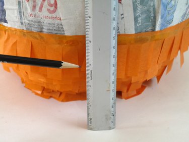 1/4 of the balloon covered in fringe, and a ruler showing the measurement.