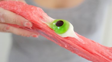Stretching edible slime with gummy eyeball in the center
