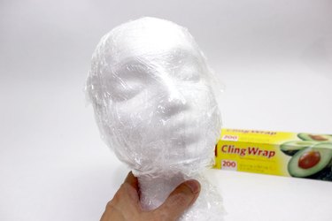 Wrap a foam head with plastic cling wrap