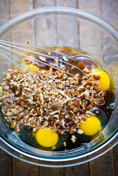 Combine the eggs, pecans, corn syrup, sugars, butter, and salt.