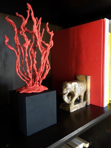 DIY faux coral sculpture on a bookshelf.
