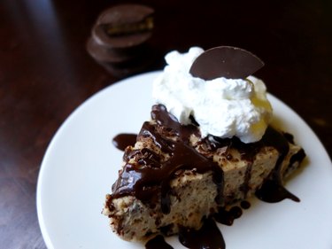 No-bake low-carb peanut butter cream cheese pie with a chocolate almond crust, garnished with sugar-free ganache, whipped cream, and peanut-butter cup.