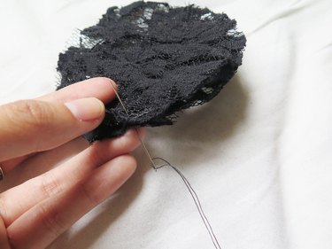 Sewing the two pieces of lace together around the wire ear.