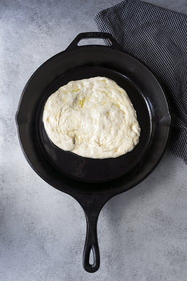 Pizza dough in cast iron skillet