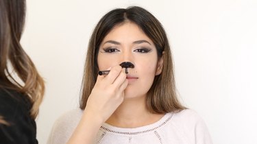 Draw the nose and mouth with liquid liner