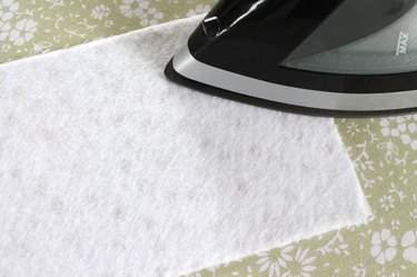Use an iron to fuse the fleece to the fabric.