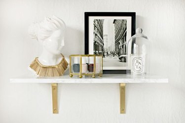 Faux marble shelf with gold brackets