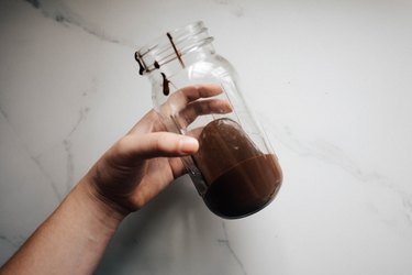 Pour the melted chocolate into the bottom of a glass jar.