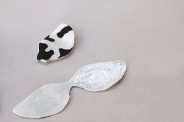 ...A cow ear shape cut from fabric with fabric glue spread across to the reverse side