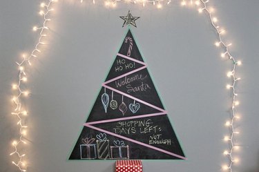 A chalkboard tree surrounded in lights
