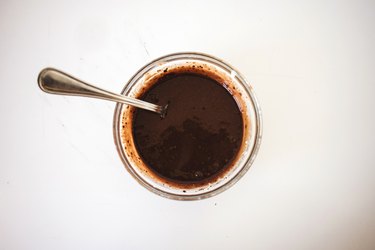 Glossy and smooth chocolate espresso sauce in a small mixing bowl.