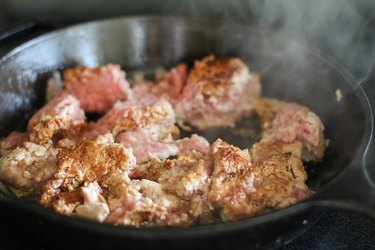 Ground meat browning in a skillet