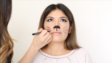 Draw cat whiskers with liquid liner