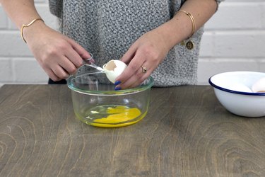 Cutting top out of raw egg.