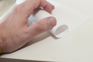 Roll the paper into a cylinder