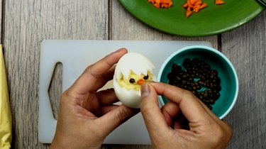 Assembling deviled egg Easter chicks.