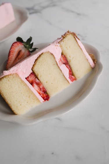 A slice of Sparkling Strawberry Rosé Cake is both delicious and beautiful.