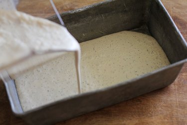 Ice cream base being poured into a loaf pan.