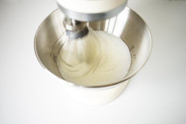 Egg whites becoming foamy in a stand mixer.