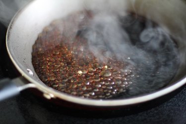 Boiling balsamic vinegar in a skillet