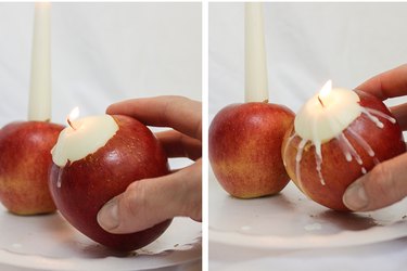 Dripping wax from tea light candle onto apple.