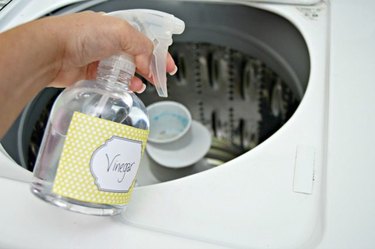 Spraying vinegar into top loading washing machine