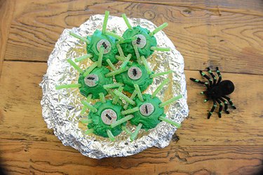 Green cupcakes decorated to look like alien eyes